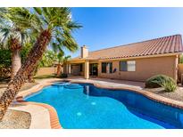 Stunning backyard pool and spa with mature landscaping and plenty of space for entertaining at 1182 E Harrison St, Gilbert, AZ 85295