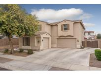 Charming two-story home featuring a three-car garage and desert landscaping at 15658 W Cortez St, Surprise, AZ 85379