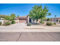 Charming single-story home features a well-maintained lawn and a two-car garage at 17008 W Sonora St, Goodyear, AZ 85338