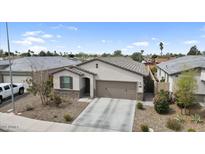 Charming single-story home with a two-car garage and low maintenance desert landscaping in front yard at 1924 S 82Nd Cir, Mesa, AZ 85209