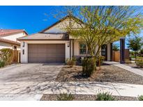 Charming single-story home featuring a two-car garage and well-maintained landscaping at 19305 S 209Th Pl, Queen Creek, AZ 85142