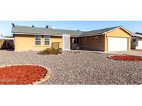 Charming single-story home with a two-car garage and low maintenance desert landscaping at 2581 E Commonwealth Cir, Chandler, AZ 85225