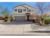Two-story home featuring a two-car garage, neutral stucco, and a brick-paved driveway with tidy landscaping at 2943 W Thorn Tree Dr, Phoenix, AZ 85085