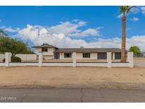 Charming single-Gathering home featuring a well-maintained yard and neutral color scheme at 5038 W Acoma Dr, Glendale, AZ 85306