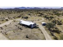 Expansive property featuring a charming home with mountain views and abundant desert landscape at 50525 W Whirly Bird Rd, Maricopa, AZ 85139