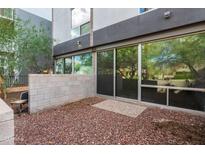 Modern patio with sliding glass doors and neutral red gravel at 525 E Willetta St # 2, Phoenix, AZ 85004
