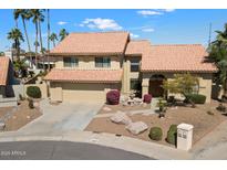 Beautiful two-story home with a terracotta roof, desert landscaping, and an inviting water feature in the front yard at 5530 E Beck Ln, Scottsdale, AZ 85254