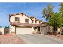 Charming two-story home featuring a spacious three car garage and neutral toned stucco exterior at 6804 S 45Th Gln, Laveen, AZ 85339