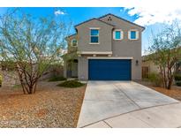 Two-story home with a blue garage door, desert landscaping, and neutral paint scheme at 6823 W Getty Dr, Phoenix, AZ 85043