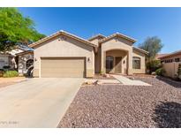 Charming single-story home featuring a two-car garage and low maintenance desert landscaping at 6970 W Paso Trl, Peoria, AZ 85383