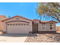 Charming single-story home featuring a well-manicured rock garden and a two-car garage at 7359 W Rancho Dr, Glendale, AZ 85303