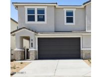 Charming two-story home features a two-car garage and well-maintained landscaping at 1127 E Mcneil St, Phoenix, AZ 85042
