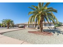 Inviting home with desert landscaping, mature palm trees and a covered parking area at 136 N 63Rd St, Mesa, AZ 85205