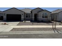 Charming single-story home with a well-maintained front yard and a two-car garage at 15429 W Cottontail Ln, Surprise, AZ 85387