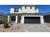 Two-story home with a dark garage door and well-maintained landscaping at 17704 W Mission Ln, Waddell, AZ 85355