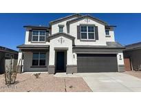 Charming two-story home boasts a neutral color scheme, a two-car garage, and a well-maintained front yard at 17744 W Hatcher Rd, Waddell, AZ 85355