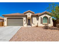 Charming single-story home with a well-maintained front yard, desert landscaping, a two-car garage, and a tile roof at 1980 E Horseshoe Dr, Chandler, AZ 85249
