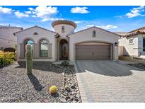 Stunning home features a decorative tower, three car garage, and desert landscaping at 2040 N Dome Rock --, Mesa, AZ 85207