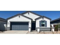 Charming single-story home featuring a two-car garage, low-maintenance landscaping, and a classic architectural design at 25356 W Sunland Ave, Buckeye, AZ 85326