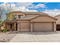 Attractive two-story home featuring a terracotta tile roof and a spacious three-car garage at 3239 E San Manuel Rd, San Tan Valley, AZ 85143