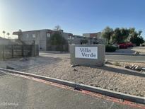 Welcome to Villa Verde community showcasing well-maintained landscaping and residential buildings against a clear blue sky at 4744 E Portland St, Phoenix, AZ 85008