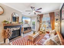 Cozy living room featuring a fireplace, ceiling fan, and comfortable seating at 9451 E Becker Ln # 2013, Scottsdale, AZ 85260