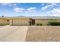 Charming single-story home with a well-maintained front yard and a two-car garage at 12943 W Maplewood Dr, Sun City West, AZ 85375