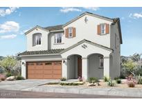 Charming two-story home featuring a welcoming front porch, a two-car garage, and desert landscaping at 14467 W Sand Hills Rd, Surprise, AZ 85387