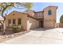 Inviting two-story home featuring a three-car garage and desert landscaping at 16291 W Crenshaw Dr, Surprise, AZ 85379