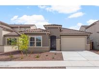Charming single-story home with neutral stucco, tile roof and a two-car garage, set against a blue sky at 17809 W Getty Dr, Goodyear, AZ 85338