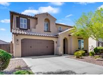 Charming two-story home features a neutral color palette, two-car garage, and well-maintained landscaping at 1961 E Stacey Rd, Gilbert, AZ 85298