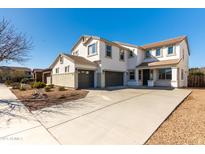 Inviting two-story home with a spacious three-car garage and a well-maintained front yard at 22302 E Camina Plata --, Queen Creek, AZ 85142