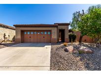 Charming single-story home featuring a two-car garage and a well-maintained desert landscape at 26735 N 127Th Dr, Peoria, AZ 85383