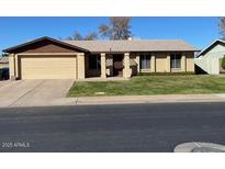 Charming single-level home featuring a two-car garage and a well-maintained lawn at 3502 E El Moro Ave, Mesa, AZ 85204
