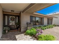 Inviting home entrance with wood accents, stylish door, and lovely landscaping enhancing curb appeal at 8238 E San Miguel Ave, Scottsdale, AZ 85250