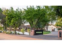 Lush landscaping frames the brick-gated entrance of this beautiful home at 8602 E Gary Rd, Scottsdale, AZ 85260