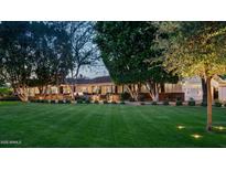Expansive front lawn and meticulous landscaping enhance this home's curb appeal with mature trees and lighting at 8602 E Gary Rd, Scottsdale, AZ 85260