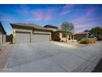 Beautiful single-story home with a spacious driveway and well-maintained landscaping, creating curb appeal at 14442 W Lexington Ave, Goodyear, AZ 85395