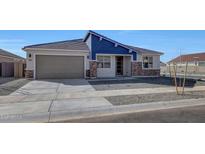 Charming single-story home featuring blue accent siding and a two-car garage at 14761 W Tether Trl, Surprise, AZ 85387