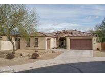 Charming single-story home featuring desert landscaping, a tile roof, and a two-car garage, capturing curb appeal at 1712 W Aloe Vera Dr, Phoenix, AZ 85085