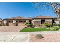 Charming single-story home featuring a three-car garage and professionally landscaped front yard at 19888 E Russet Rd, Queen Creek, AZ 85142