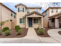 Charming two-story home featuring neutral stucco, shutters, and a covered front porch with neatly landscaped yard at 2449 N 73Rd Dr, Phoenix, AZ 85035