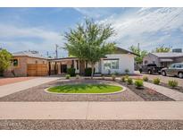 Charming single-story home with a well-manicured front yard and tasteful landscaping at 291 N Washington St, Chandler, AZ 85225