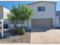 Contemporary two-story home with stucco siding, a two-car garage, and desert landscaping at 3041 S Country Club Way, Tempe, AZ 85282