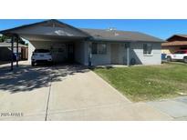 Charming single-story home featuring a carport and well-maintained front lawn at 3504 E Carol Ave, Mesa, AZ 85204