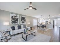 Bright and airy living room featuring modern decor and an open-concept design leading to the kitchen at 3522 E Edna Ave, Phoenix, AZ 85032