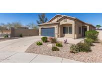 Charming single-story home featuring a desert landscape, arched entry, and a two-car garage in a well-maintained community at 37180 W Mondragone Ln, Maricopa, AZ 85138