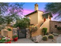 Stunning home showcasing a stucco exterior, well-manicured landscaping, and a welcoming stone pathway at 42171 N Saguaro Forest Dr, Scottsdale, AZ 85262