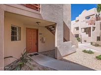 Inviting condo exterior featuring a private entrance, stucco facade, and well-maintained landscaping at 4850 E Desert Cove Ave # 107, Scottsdale, AZ 85254