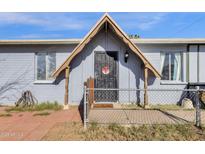 Charming home featuring a secure gated front porch and light blue exterior paint at 5517 N 61St Ln, Glendale, AZ 85301